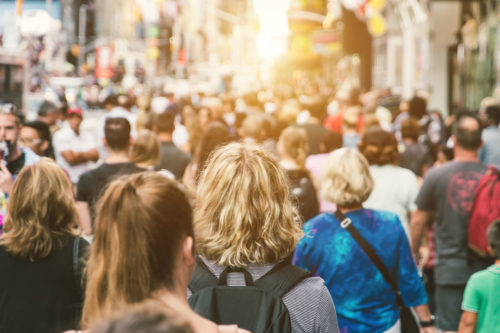 people walking down a busy high street
