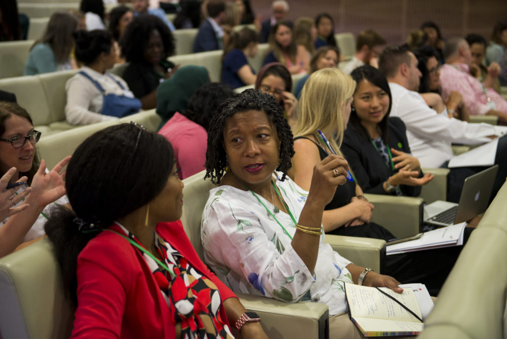 delegates talking at an event in an auditorium