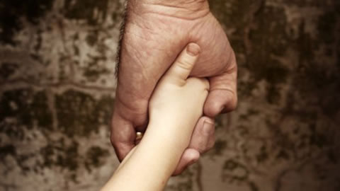 a child's hand in an adult hand