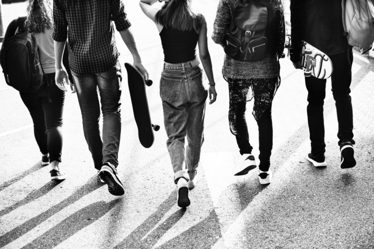 A group of young people walking away from the camera