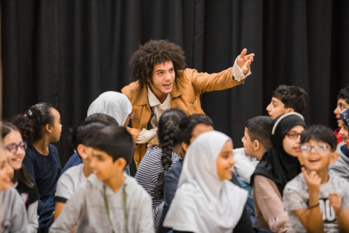 Kids and teacher sitting down