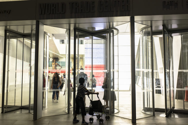 child in front of revolving doors