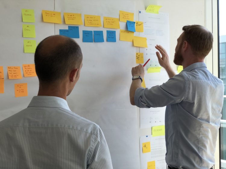 two people working on post it notes