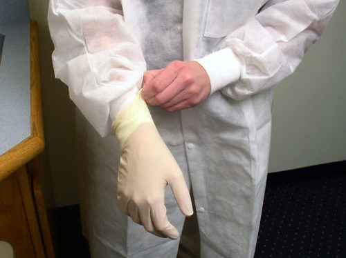 person wearing surgical gloves