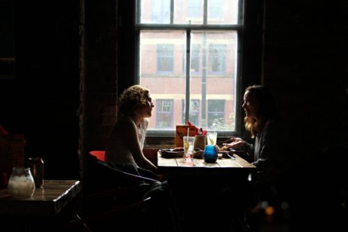 two people talking in a restaurant