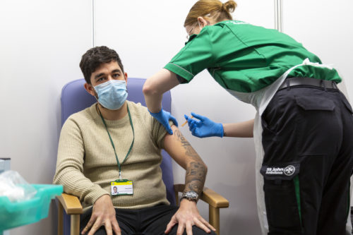 St John Ambulance volunteer vaccinator with citizen Greg Hobbs Jan 2021 London ExCel