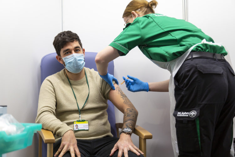 St John Ambulance volunteer vaccinator with citizen Greg Hobbs Jan 2021 London ExCel