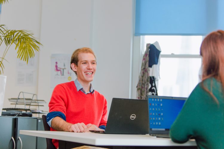 Man smiling with laptop
