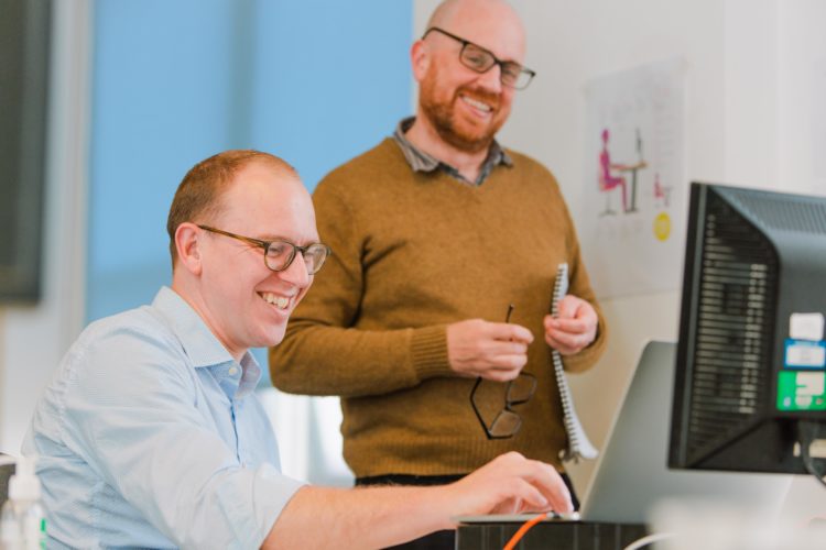 Two men looking at a computer