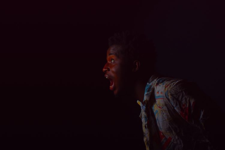 A man shouting into darkness