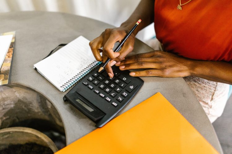 A close up of women using a calculator