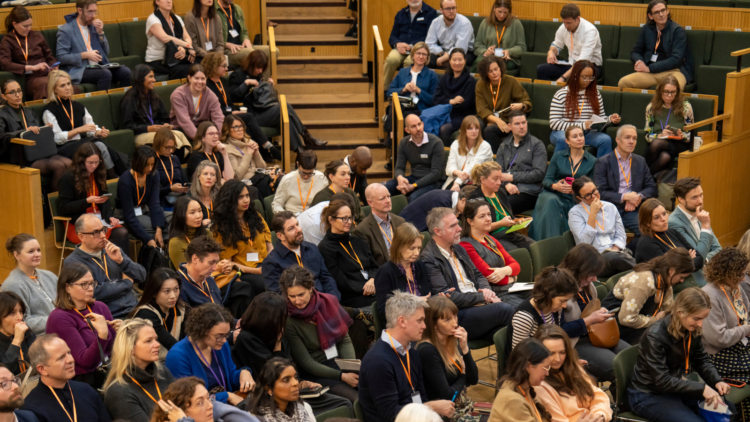 People sat listening to a session at an NPC event